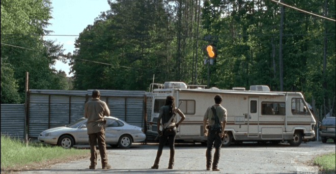 In the next scene, we see Rick, Michonne, and Morgan running ahead of the dreaded walker parade. Rick radios Glenn, checks in. It seems Glenn and the others are right on time, ahead of the horde, at the tractor store. As they regard the barricade they set up, before, RV and car parked in front of metal gates, Rick says,