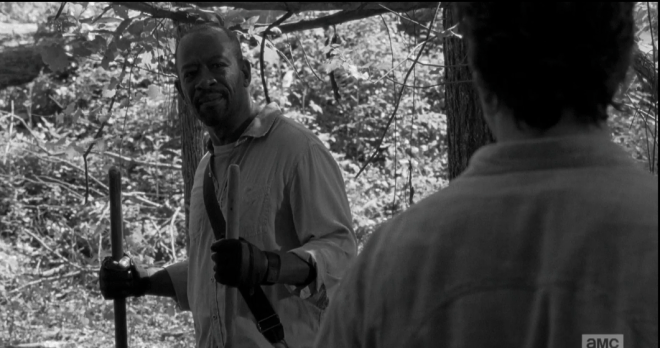 Morgan smiles at Rick, taps the shovel in his right hand a few times into the ground, says,